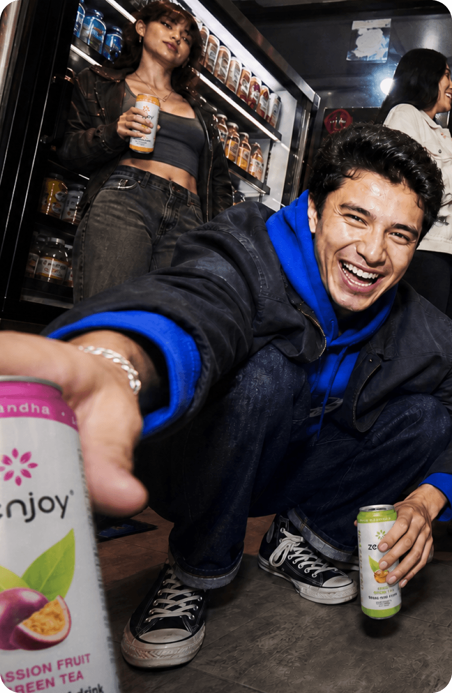 Two friends with Zenjoy cans in a corner store