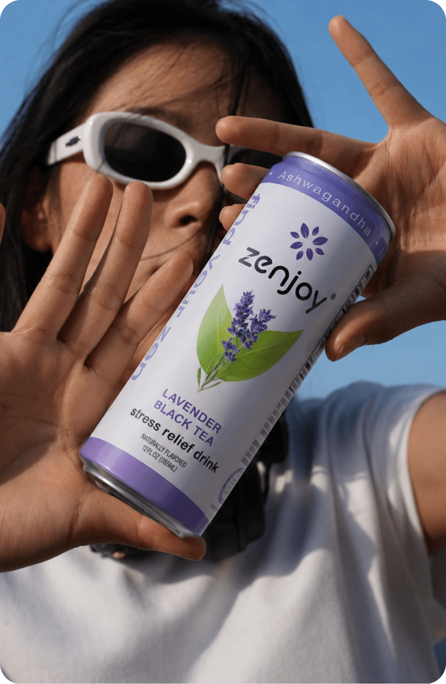 Someone holding up a Lavender Black Tea can